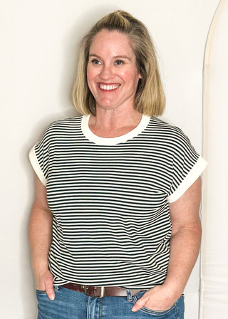 Black and white striped short sleeve top with white banding on sleeve and collar. 