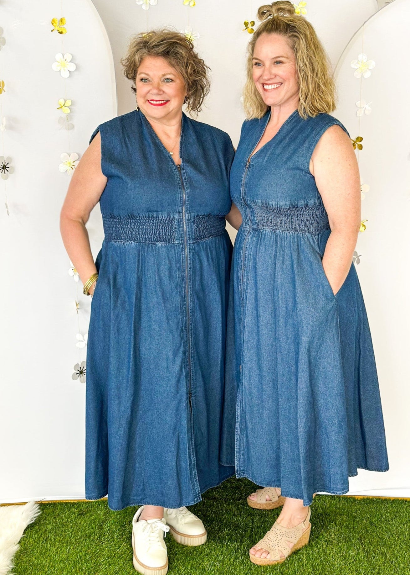 Sleeveless denim v-neck midi dress with cinched waist and pockets. Zipper closure down the front ending in a slit.  