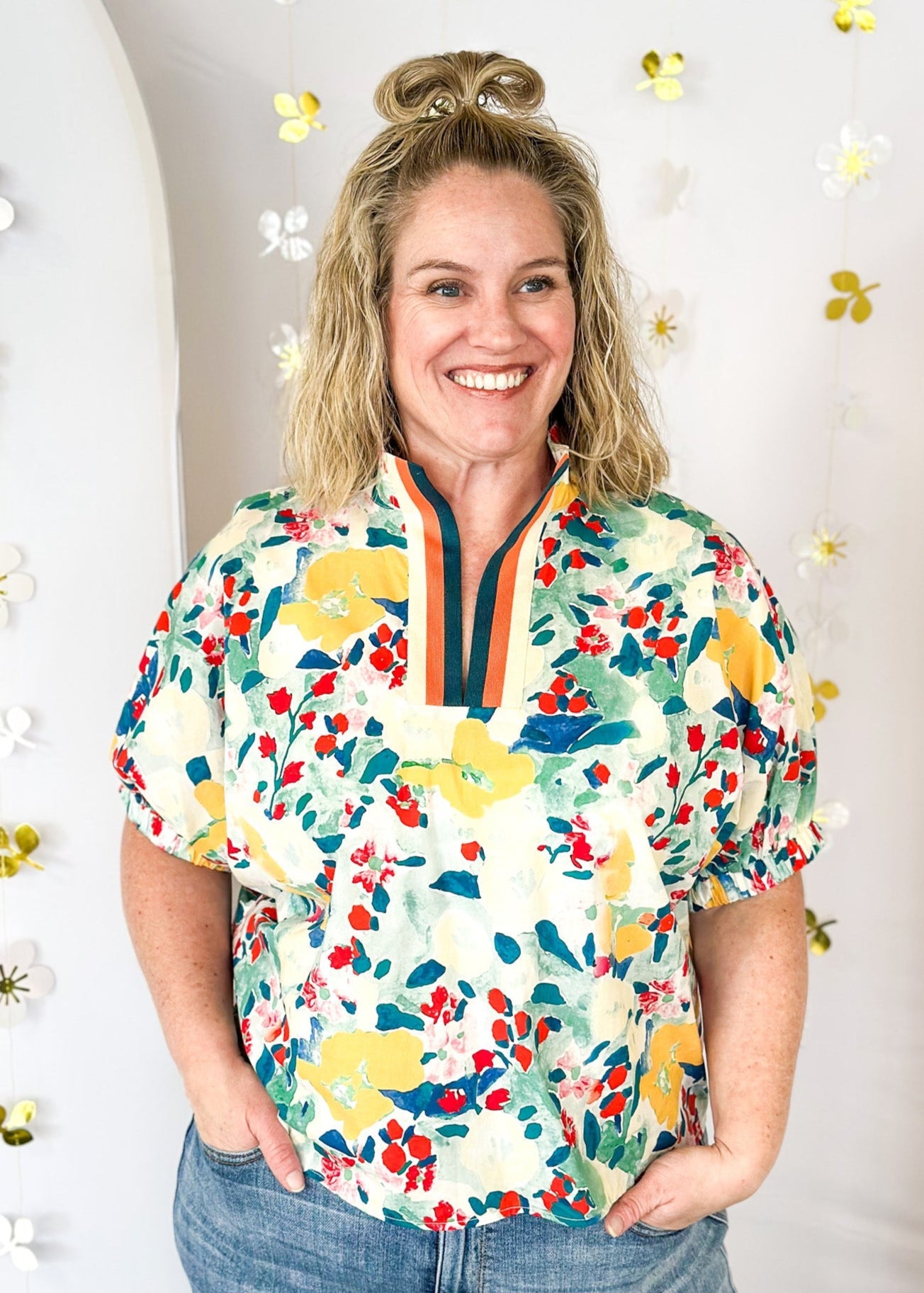 teal, yellow, red, and cream floral print short sleeve top -with striped v-neck collar and elastic cuff on sleeve 