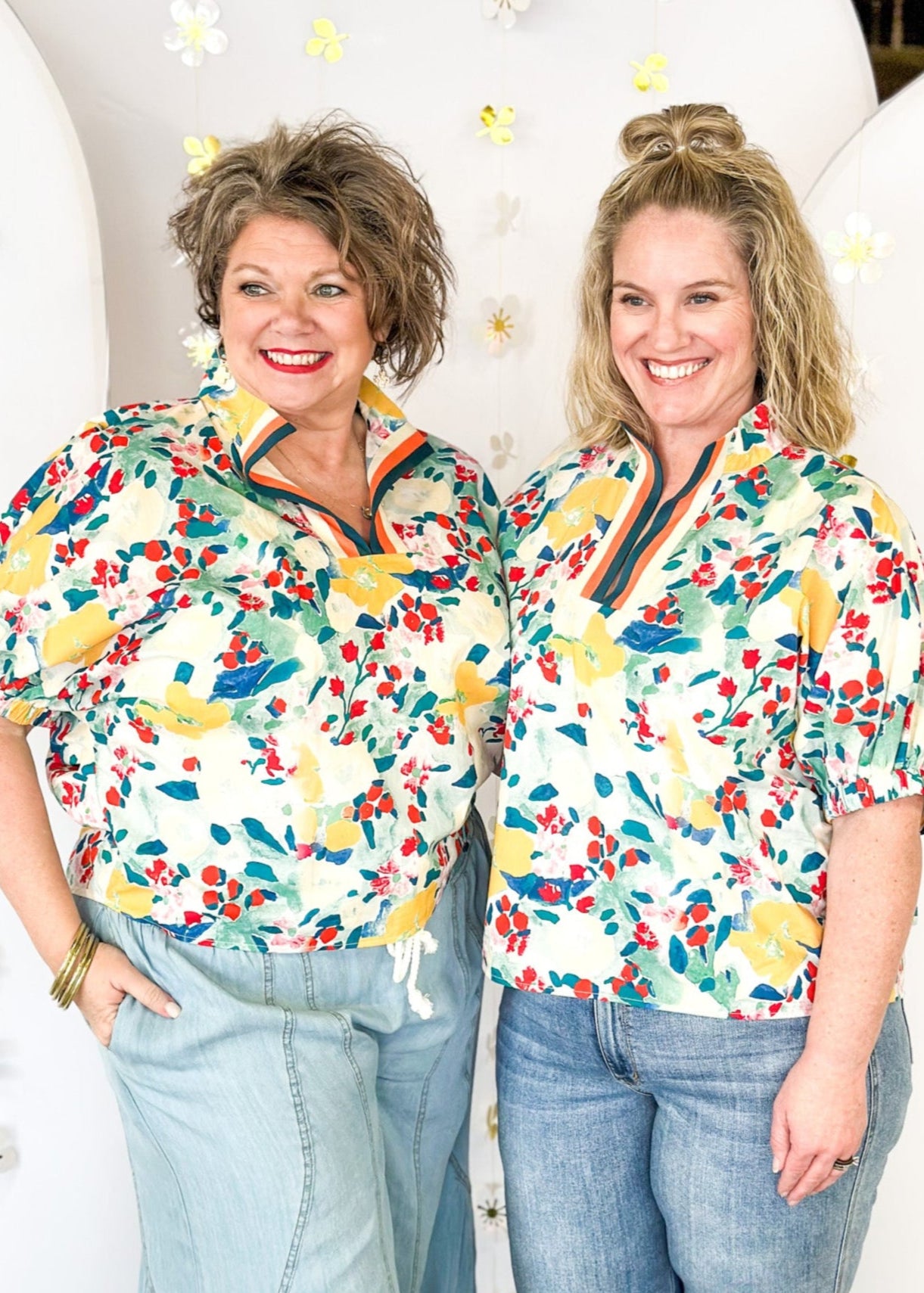 teal, yellow, red, and cream floral print short sleeve top -with striped v-neck collar and elastic cuff on sleeve 