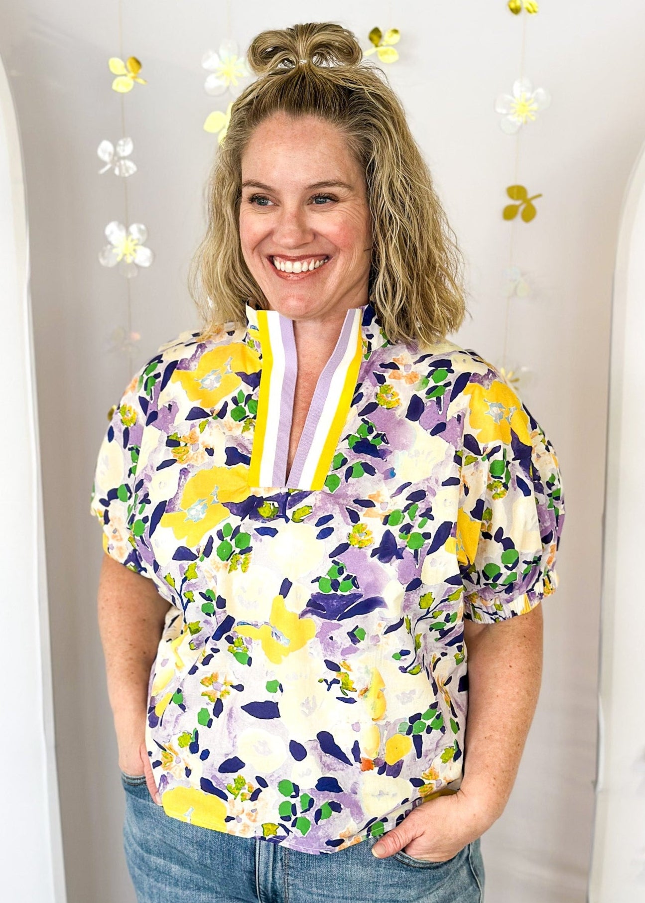 floral print short sleeve top in purple and yellow-with striped v-neck collar and elastic cuff on sleeve 