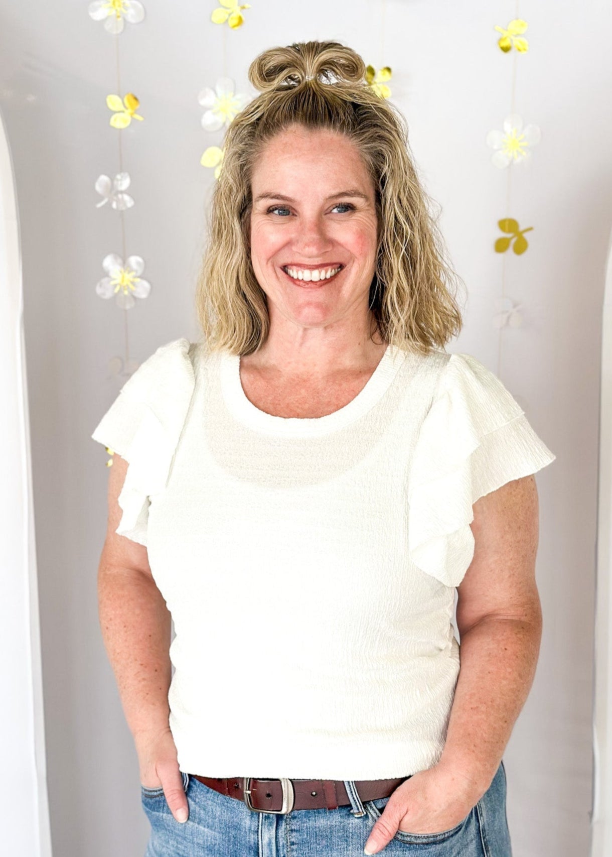 Lightweight textured short sleeve solid white top.  Round neck and ruffle sleeve.  