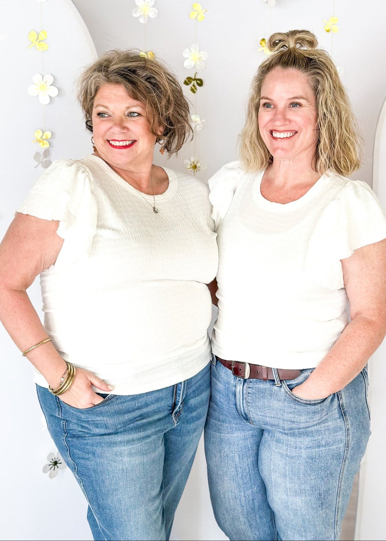 Lightweight textured short sleeve solid white top.  Round neck and ruffle sleeve.  