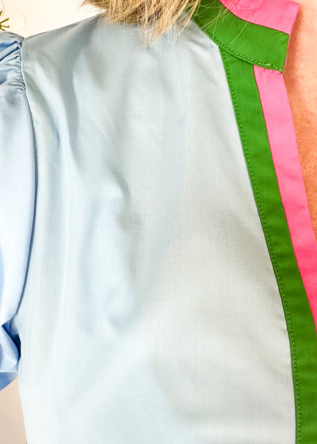 chambray v-neck short puff sleeve top with contrast striped banding around cuff and neck in pink and green