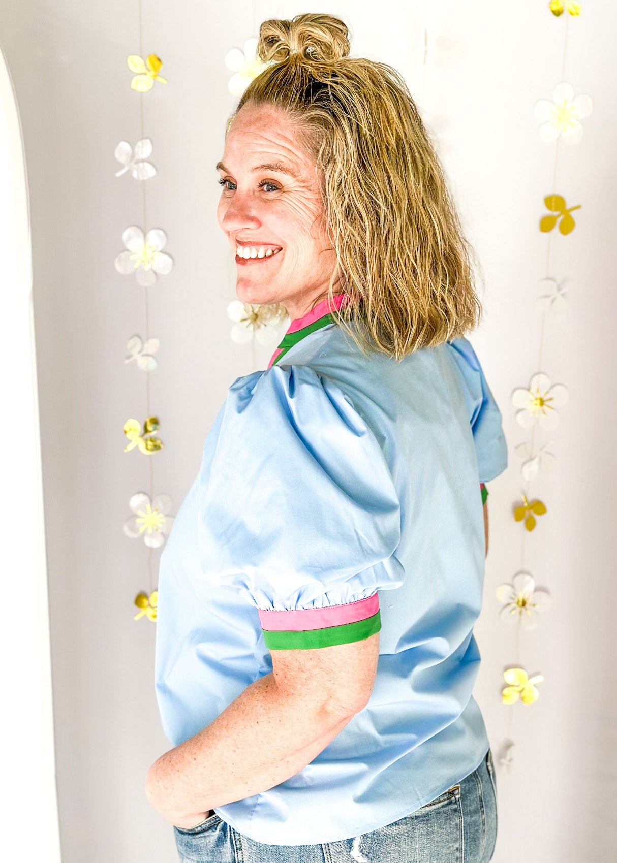 chambray v-neck short puff sleeve top with contrast striped banding around cuff and neck in pink and green