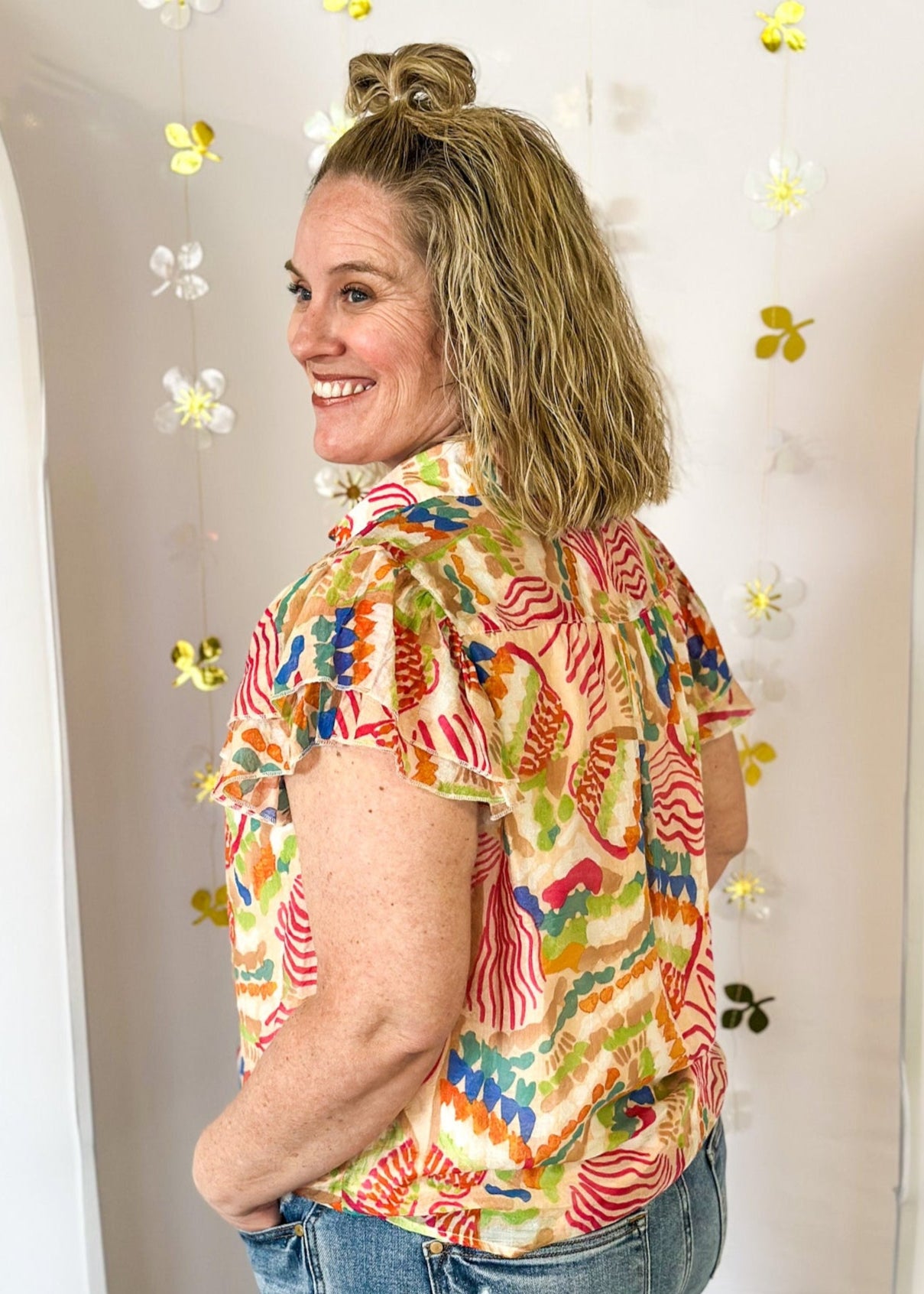 Lightweight short sleeve button up v-neck top.  Tropical print in dark pink, orange, blue, tan, and green.