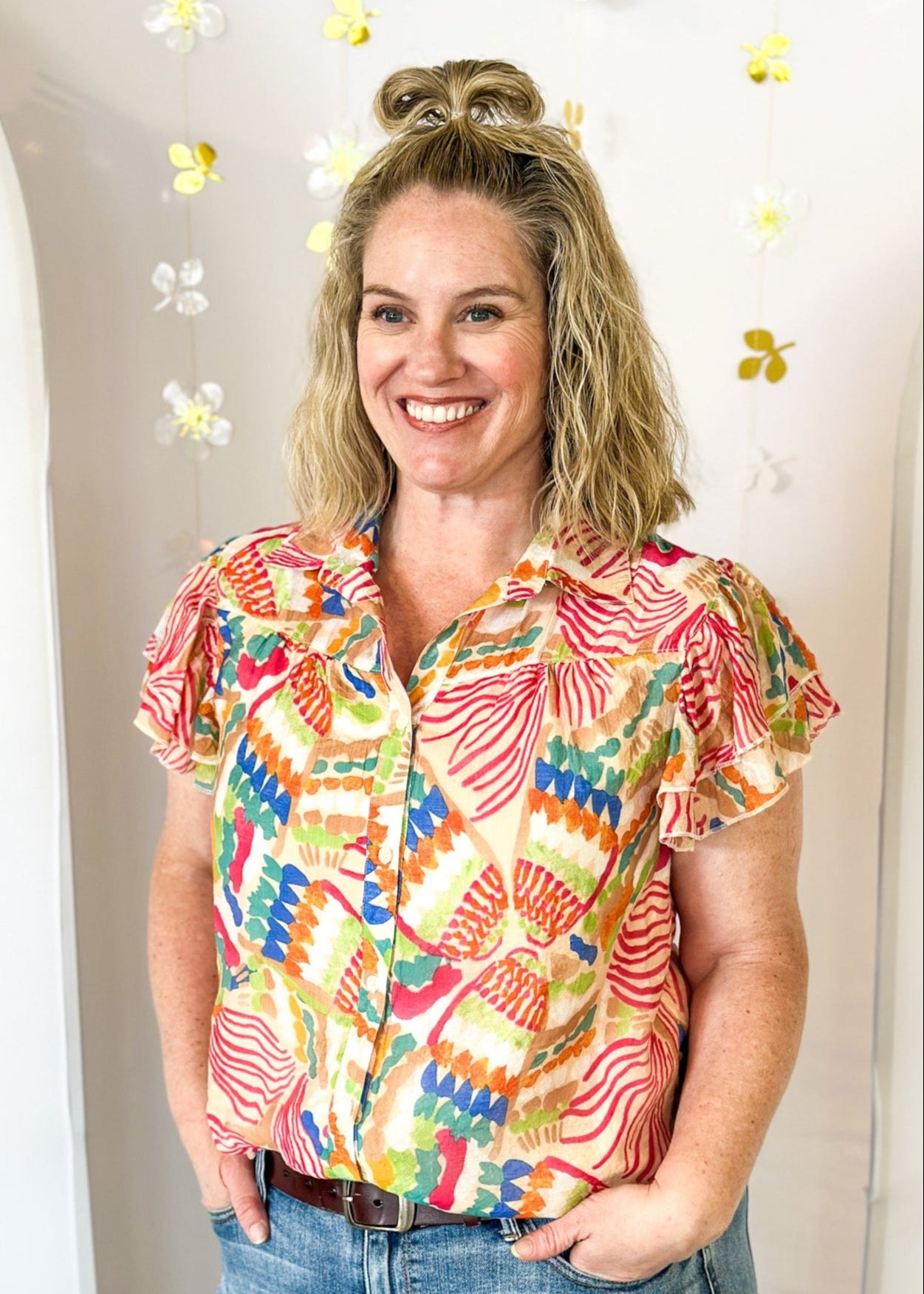 Lightweight short sleeve button up v-neck top.  Tropical print in dark pink, orange, blue, tan, and green.