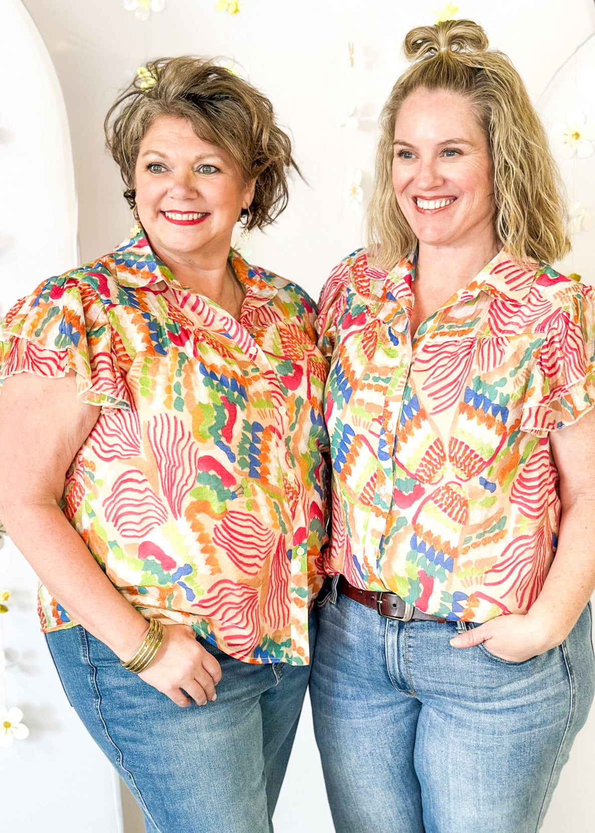 Lightweight short sleeve button up v-neck top.  Tropical print in dark pink, orange, blue, tan, and green.