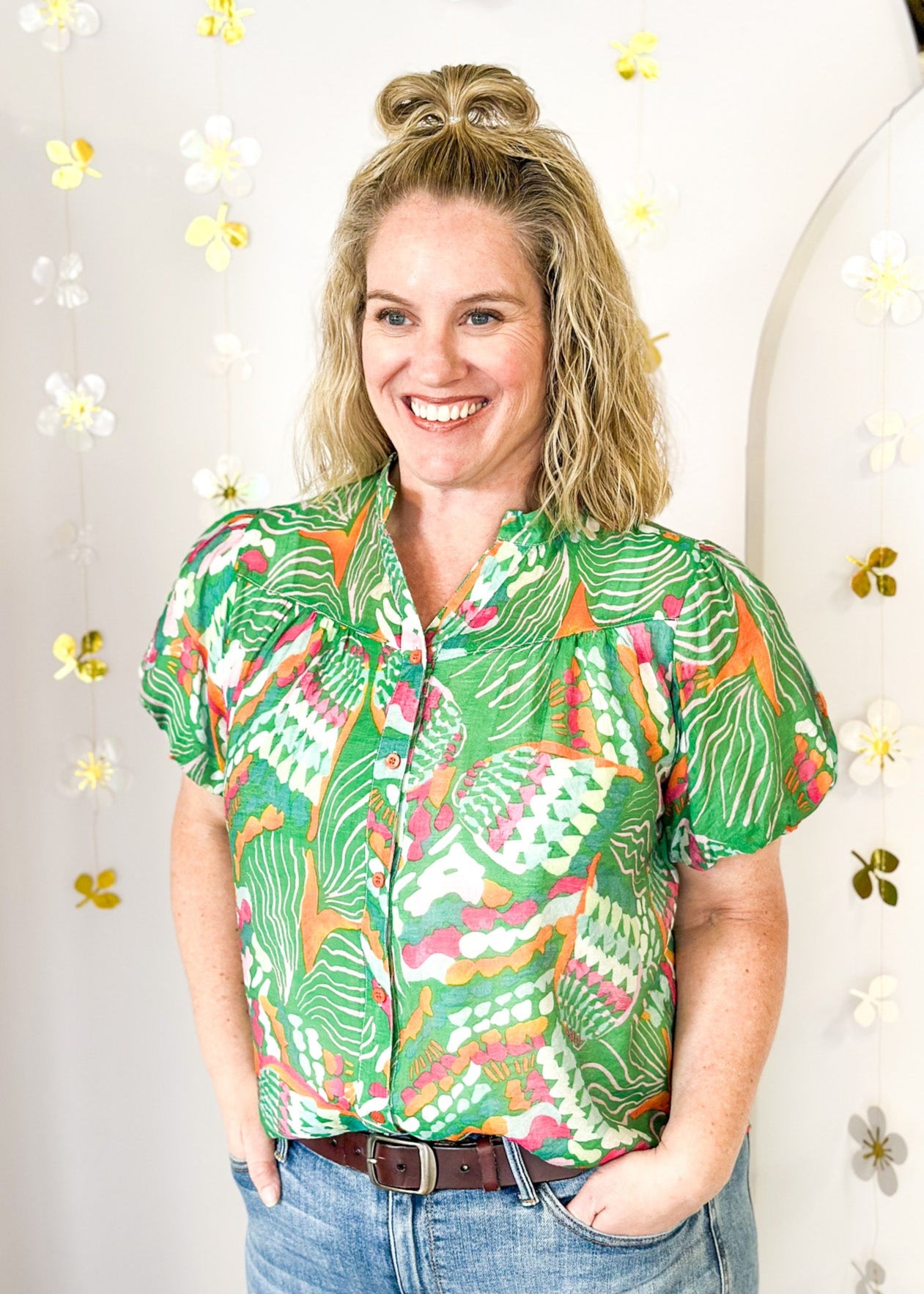 Lightweight short sleeve button up v-neck top.  Tropical print in green, white, pink and orange.  