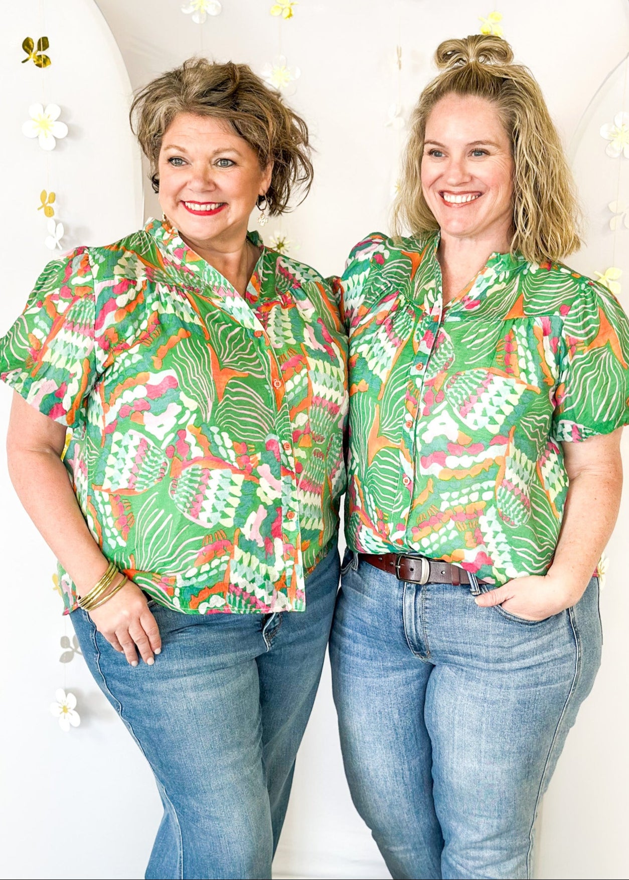 Lightweight short sleeve button up v-neck top.  Tropical print in green, white, pink and orange.  