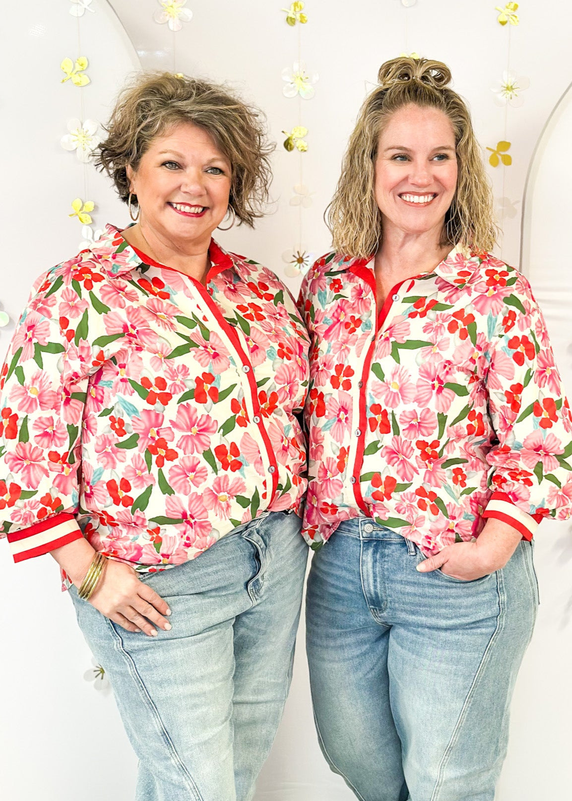 red and pink floral 3/4 sleeve top with cream and red stripe down the front and on cuff banding - cream background and green leaves, button up