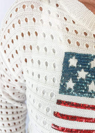 long sleeve white open knit pullover sweater with sequin american flag on the front