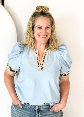 light blue puff short sleeve top w/leopard and tan trim around v-neck and cuff