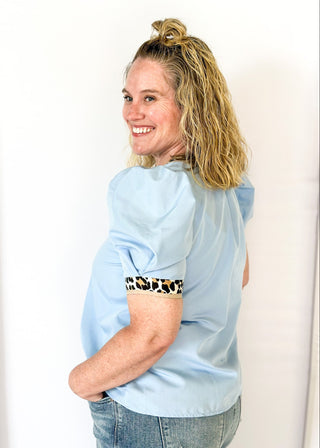 light blue puff short sleeve top w/leopard and tan trim around v-neck and cuff