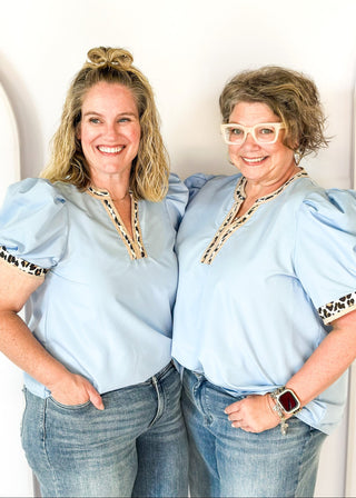 light blue puff short sleeve top w/leopard and tan trim around v-neck and cuff