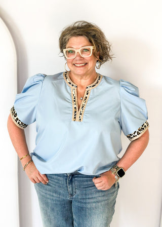 light blue puff short sleeve top w/leopard and tan trim around v-neck and cuff