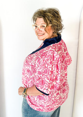 bright pink floral on white elbow length sleeve top - navy banding detail around collar and v-neck - 2 navy stripes around cuff