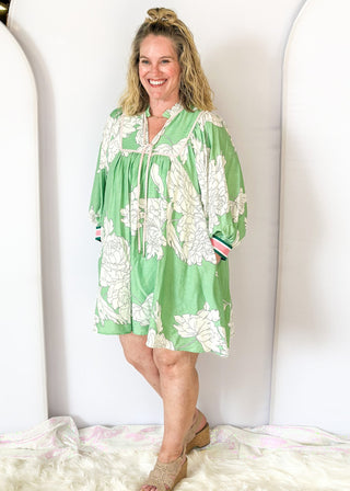Mint green Dress with large cream flowers.  Tie front collar with 3/4 oversized balloon sleeve- contrasting color stripe on the sleeve, lined with pockets. 