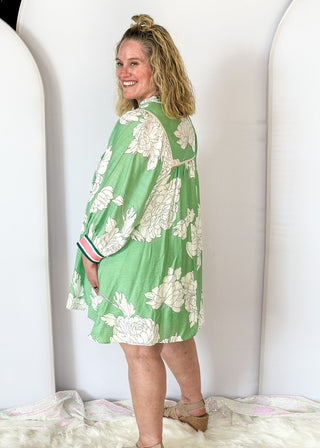 Mint green Dress with large cream flowers.  Tie front collar with 3/4 oversized balloon sleeve- contrasting color stripe on the sleeve, lined with pockets. 