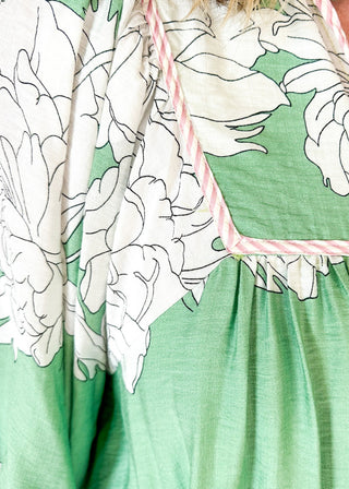 Mint green Dress with large cream flowers.  Tie front collar with 3/4 oversized balloon sleeve- contrasting color stripe on the sleeve, lined with pockets. 
