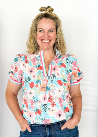 bright floral top with striped detail around arm band and v-neck - aqua, blues, pinks and white - short puff sleeve with little shoulder pads