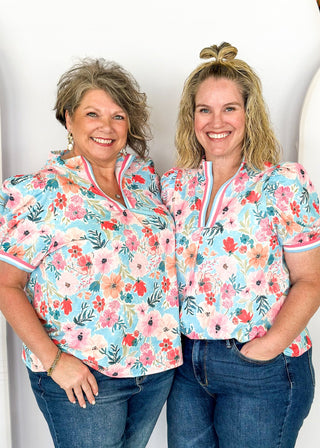 bright floral top with striped detail around arm band and v-neck - aqua, blues, pinks and white - short puff sleeve with little shoulder pads