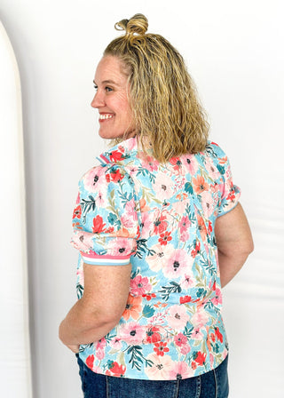 bright floral top with striped detail around arm band and v-neck - aqua, blues, pinks and white - short puff sleeve with little shoulder pads