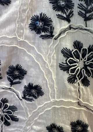 White short sleeve top with navy floral embroidery.