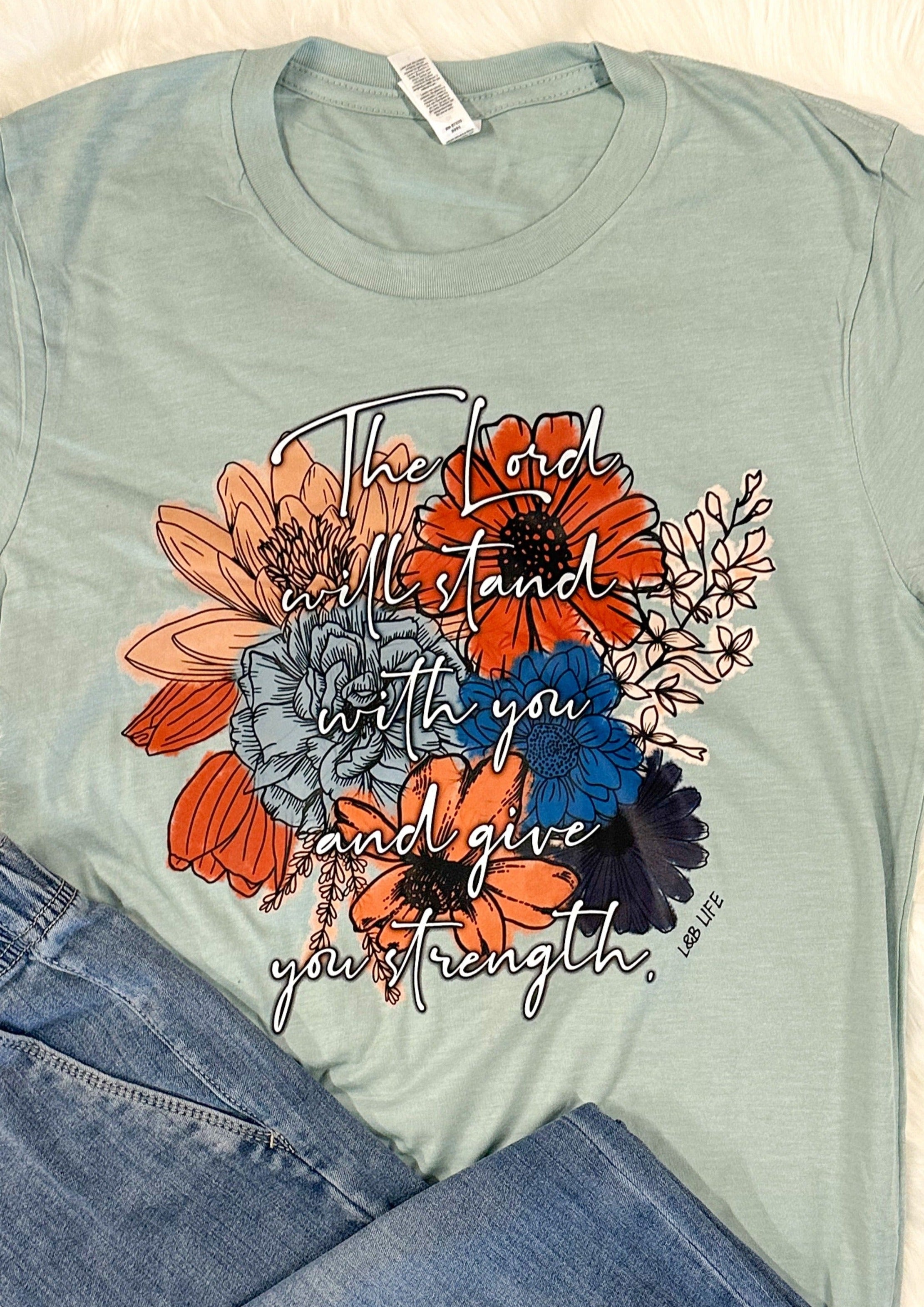 The Lord Will Stand with you andgive you strength Tee Shirt - Dusty Blue color with multi color flowers on the front and white writing