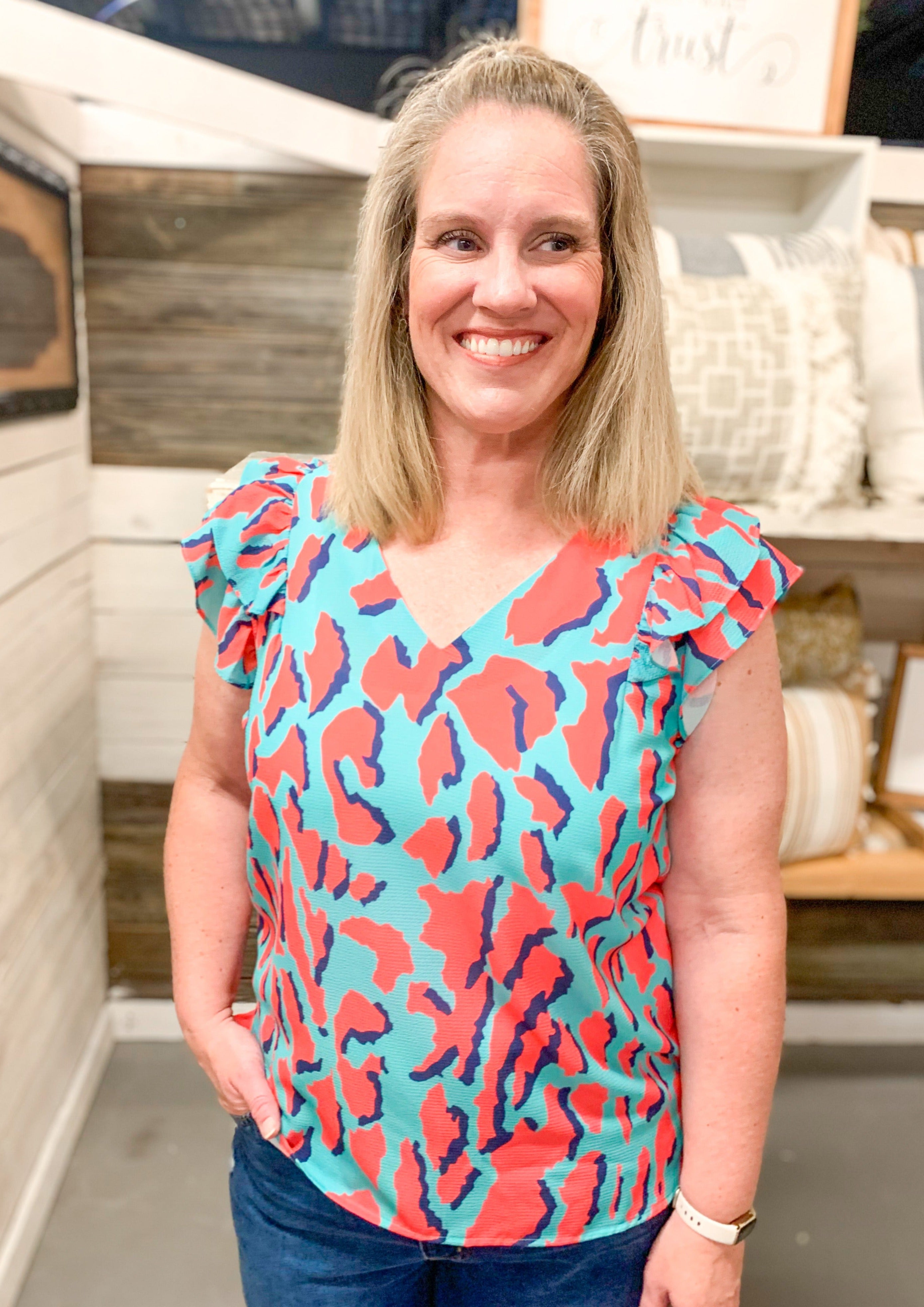 Double Ruffle Animal print Abstract Top. teal top with red animal print