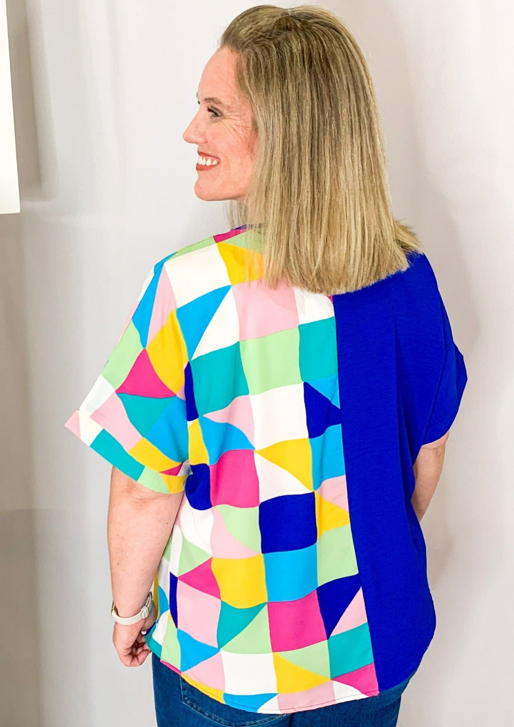 Half multicolored geometric pattern and half blue v neck top