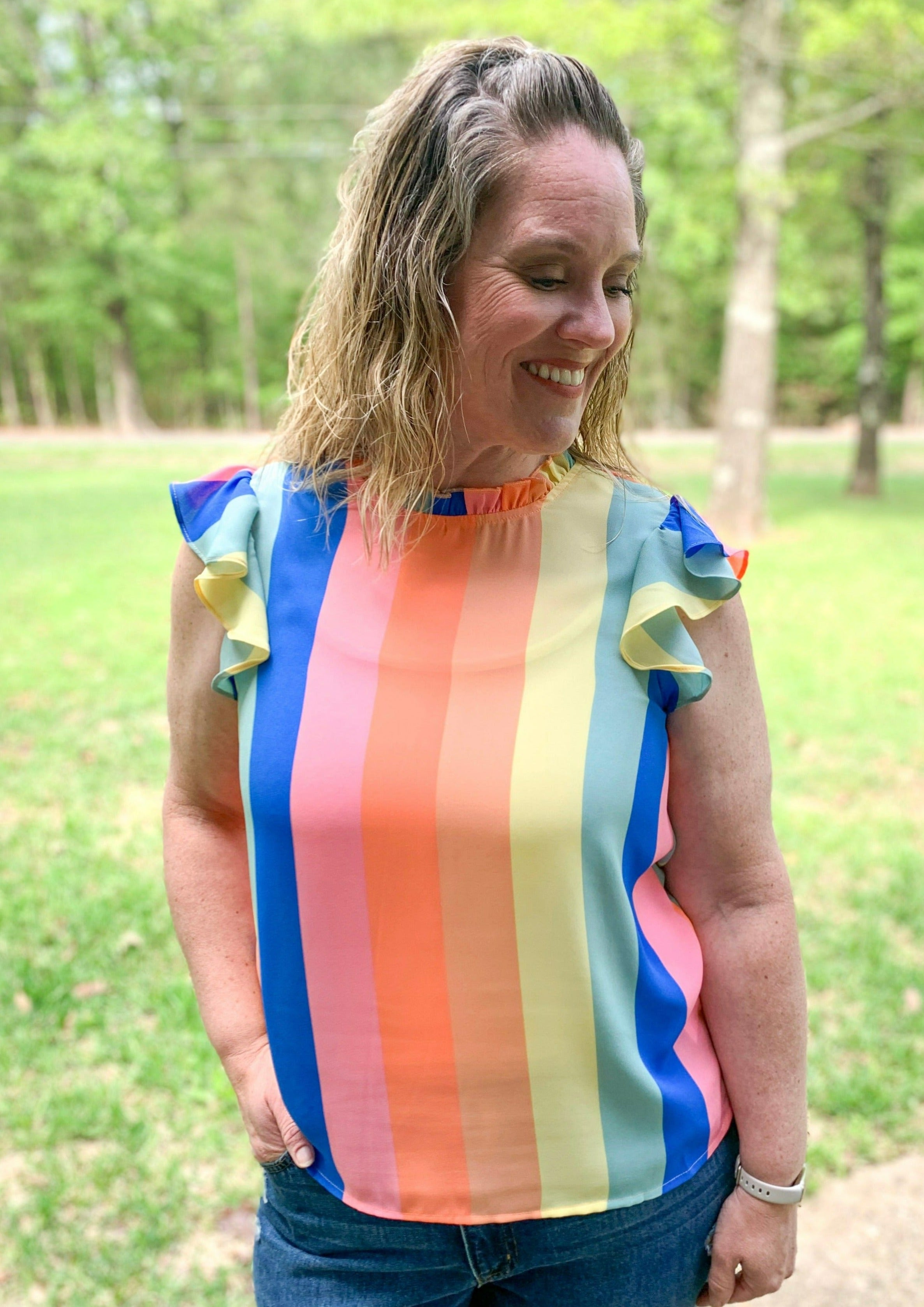 blue pink red orange yellow and green thick vertical stripes. keyhole back with button clasp. ruffle sleeves
