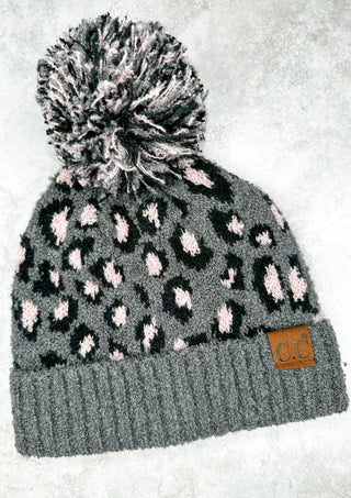 Grey cc beanie with black and pink leopard print. grey black and white pom pom on top.